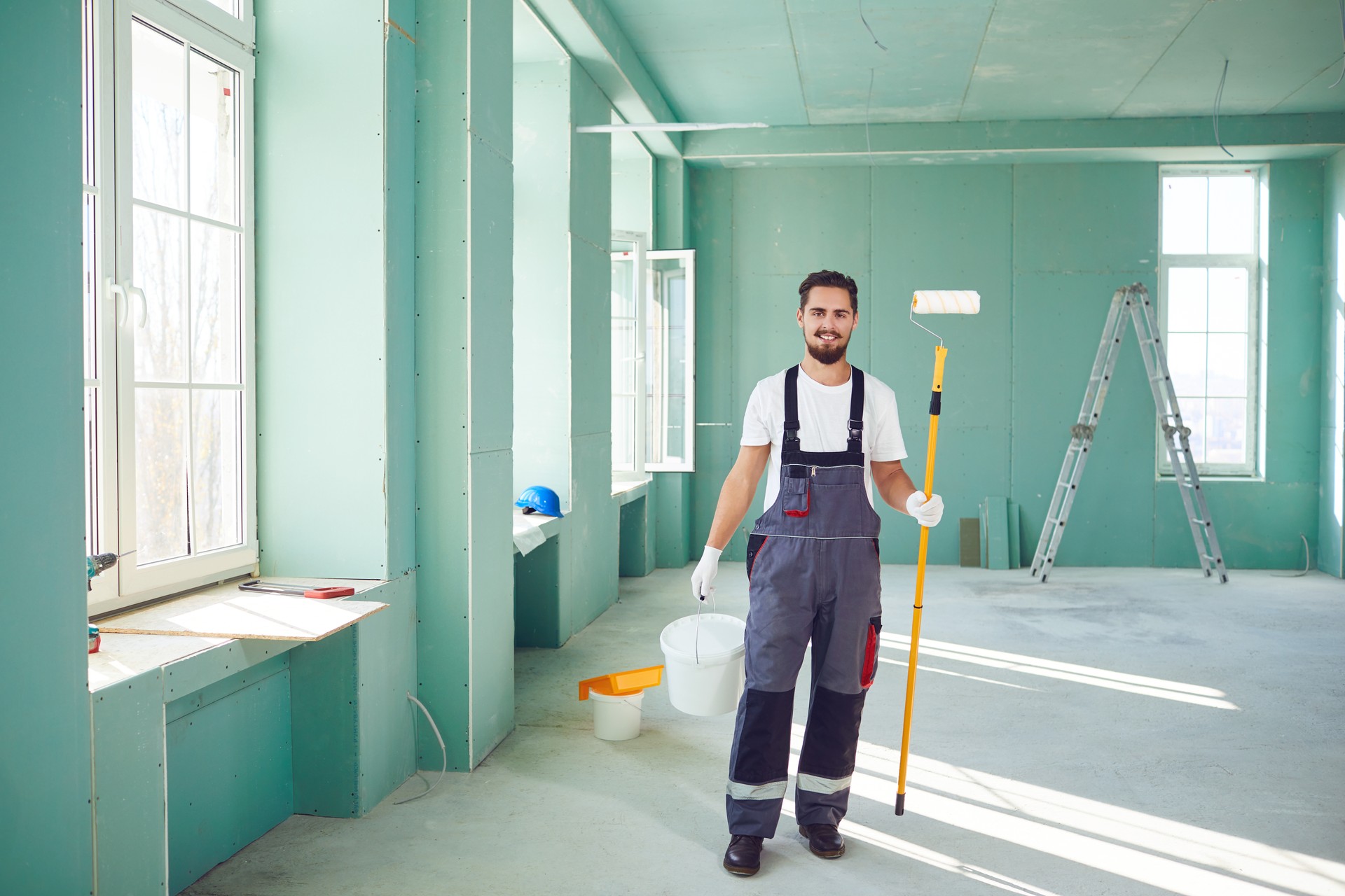 Bearded painter construction worker on a construction site.